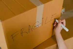 Person marking the box "Fragile"