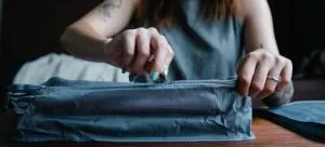 Picture of a person zipping a bag