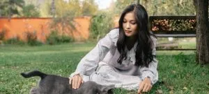 Picture of a woman enjoying her time after relocating with a pet