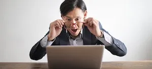 A man looking at a laptop