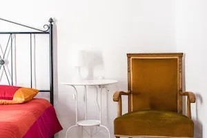 A chair and a table next to a bed