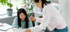 Two Asian women smiling and checking where to find good packing supplies in HK