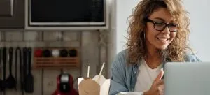 a woman reading on a lap top while trying to adapt to a new language