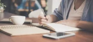 woman writing on a notebook