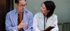 Young man and woman sitting next to each other and talking
