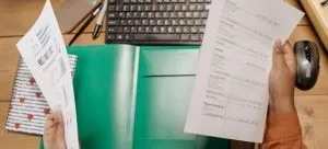 a woman holding some paperwork