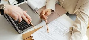 People pointing at the document