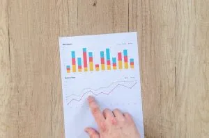 a hand pointing at a piece of paper