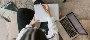 A lady uses a notebook to prepare for international move