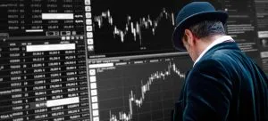 Man looking at stock exchange graphs and charts