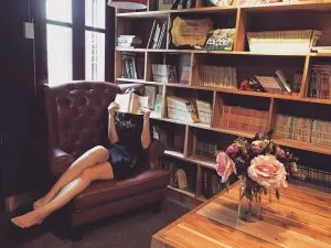 a girl sitting on sofa and reading