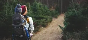 A woman carrying a baby on her back and thinking about outdoor activities for families in HK.