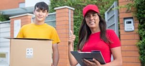 a man holding a box and a woman holding some paperwork