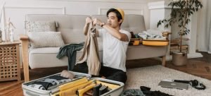 a man unpacking a suitcase