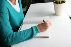 a girl writing down something