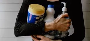 A woman who is about to create a cozy home in Hong Kong holding cleaning supplies