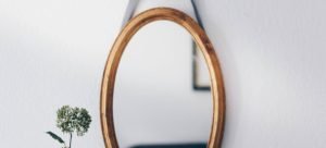 a round mirror on the wall