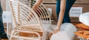 A girl packing chair with bubble wrap