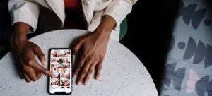 A person looking at pictures on his mobile phone