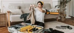 A man packing for moving from Hong Kong to less expensive city.