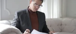Man reading through contracts.