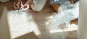 Woman and child reusing bubble wrap