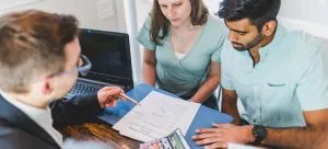Man and woman signing an contract.