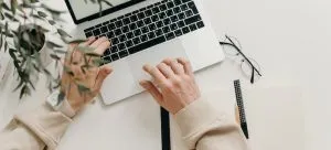 a person's hands on the laptop