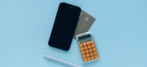 smartphone, calculator, pen and a credit card