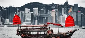 a picture of a boat with Hong Kong in the background
