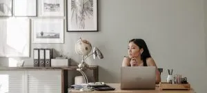 an Asian woman thinking about why Hong Kong Professionals Are Moving to the USA