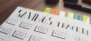 a list of savings on white paper and sticky notes