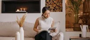 a woman sitting and reading about the best winter attractions to visit after moving to Hong Kong