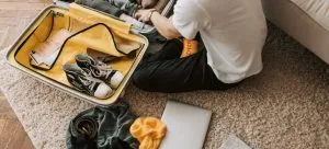 man packing a suitcase