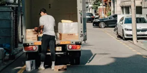 A man solving the most common storage issues by packing his boxes and shipping them to a storage unit