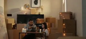 Couple sitting on the floor while discussing reusing boxes after a move to Hong Kong