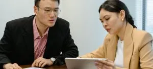 Man and woman talking about how to budget wisely in Hong Kong.