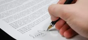 Man signing paper.
