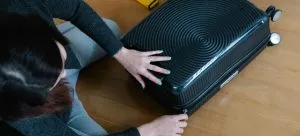 A girl packing suitcase when moving house