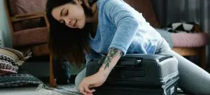 A girl packing for moving from Hong Kong to San Francisco