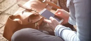 A woman using a telephone which can be a good option to search for the right person when you want to move in with a roommate.