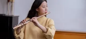 A woman playing a flute.
