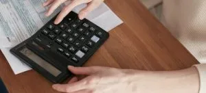 A woman using a calculator.