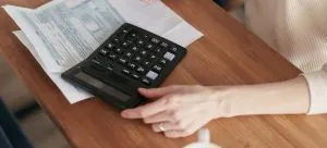 A woman using a calculator.