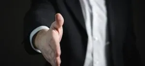 A man holding a hand to shake.