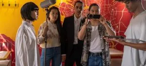 A group of people filming a movie. One of the reasons for relocating to HK for an acting career is because of the film industry.