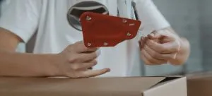 A person packing a box.
