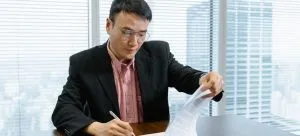 A person signing a contract.