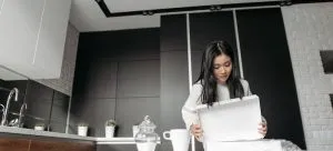 A woman unpacking a box.
