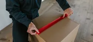 A person packing a box.